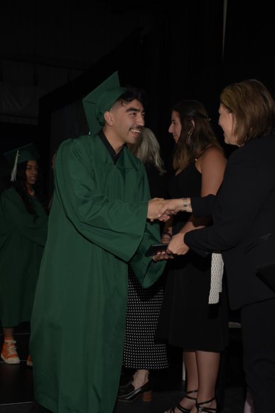 Student shaking hands with director